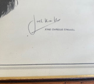 Close-up view of British wildlife artist Joel Kirk's signature next to the handwritten text reading King Charles Spaniel on a vintage art print.