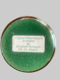A round glass frame green watercolor pigment, with a white label reading 'Original Watercolours of Ireland Elizabeth Finnegan Kill Co. Kilkare'.